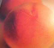 peeling a fresh peach for a pie