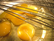 mixing eggs in a large bowl