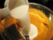 adding sugar to pumpkin pie mix